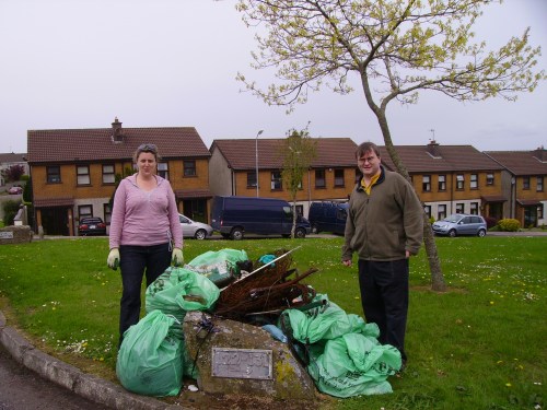 Cllr. Dominick Donnelly with Bracken Court resident Helen Maher, and the pile of rubbish collected by the residents